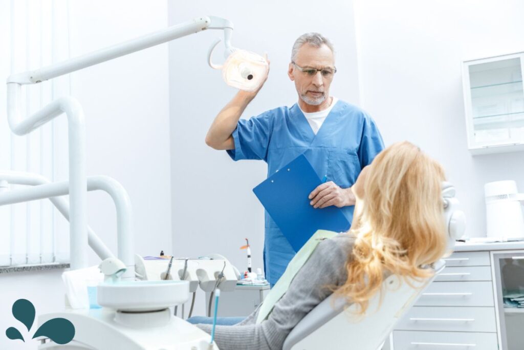 A patient in a dental chair with a dentist examining her dental health, highlighting the significance of oral care during pregnancy.