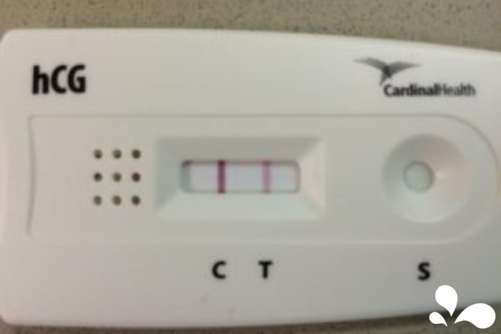 A close-up of a positive pregnancy test indicating two pink lines, a common indicator of a successful conception.