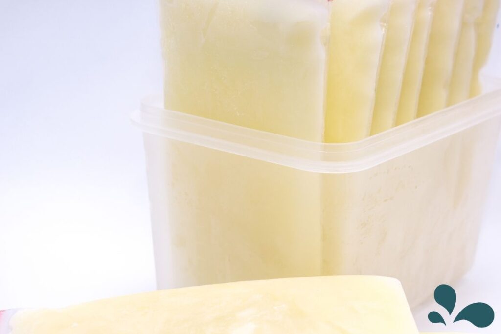 Frozen breastmilk stored efficiently in a container, showcasing the practicality of breastmilk storage for later use.
