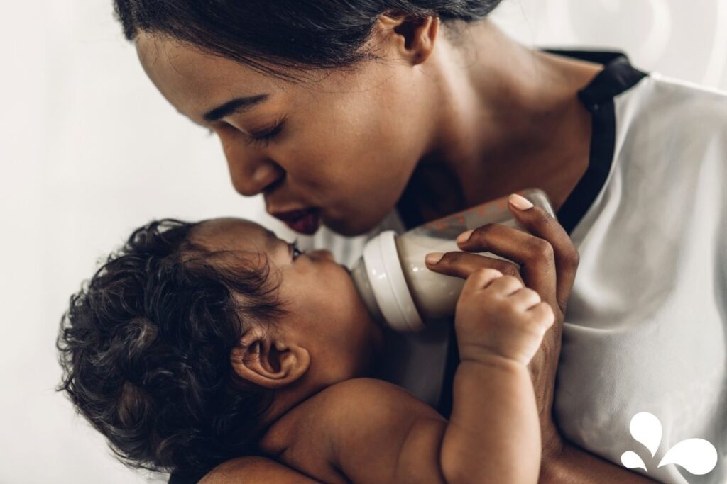 A mother intimately feeding her baby with a bottle, exemplifying the bond and care during bottle feeding moments.
