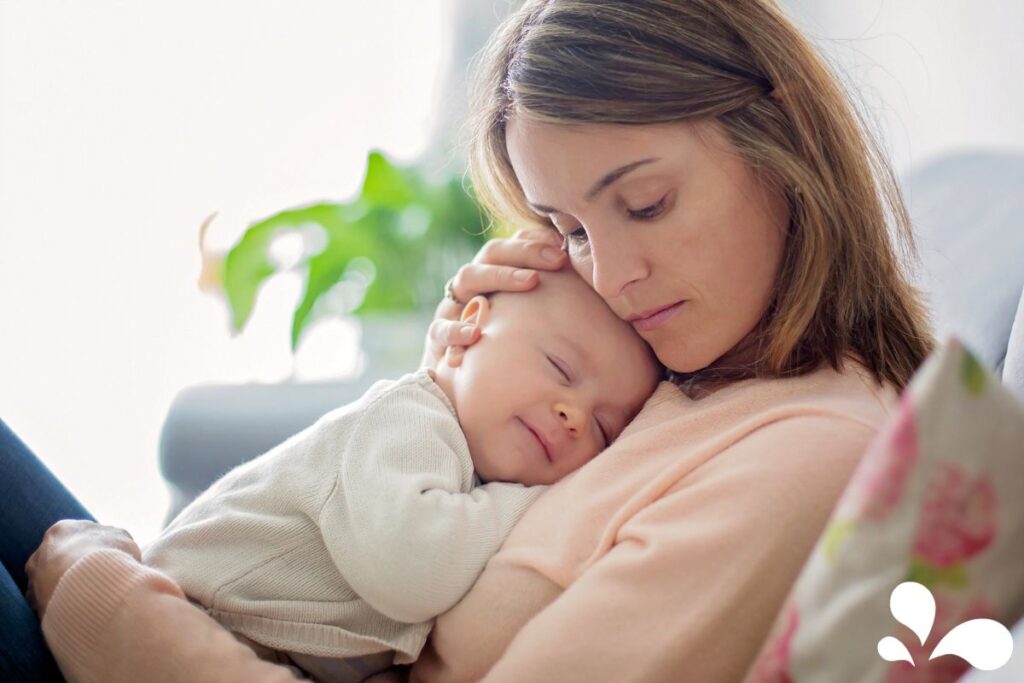 A soothing image of a mother snuggling with her sleeping baby, both content and relaxed. The gentle embrace and maternal touch signify the bond and comfort provided through breastfeeding, underlining the silent communication of love and care between mother and child.
