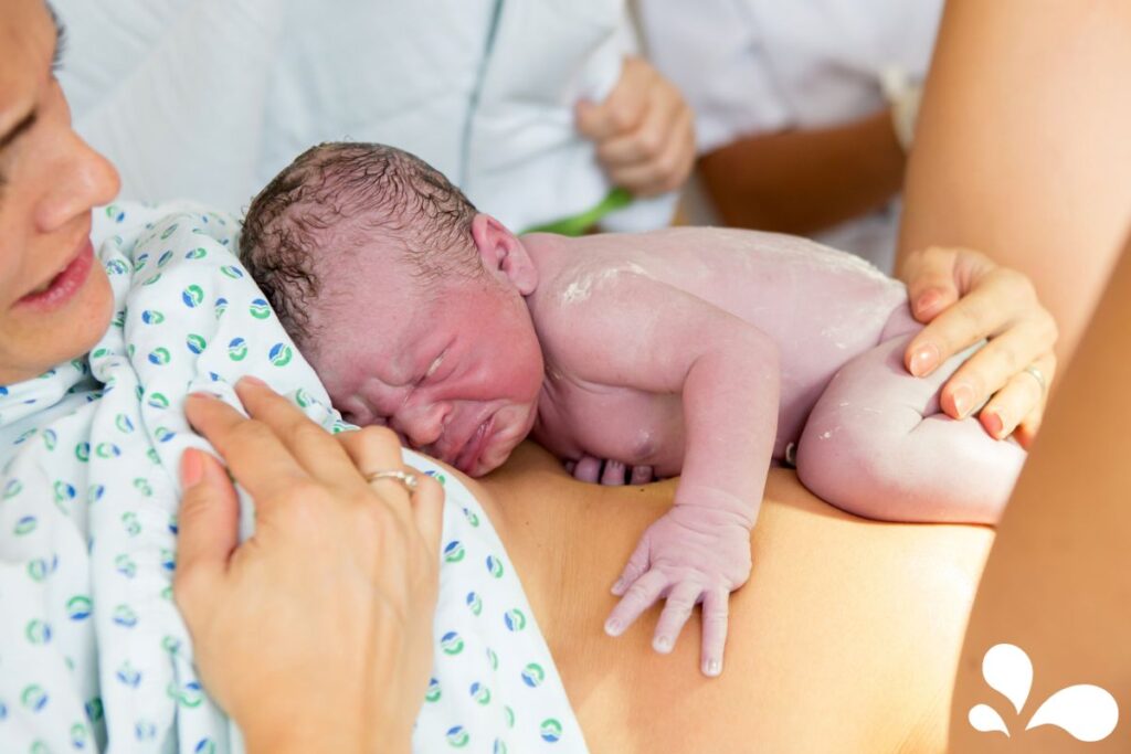 A heartwarming photo capturing the first skin-to-skin contact between a mother and her newborn baby, emphasizing the importance of immediate bonding.
