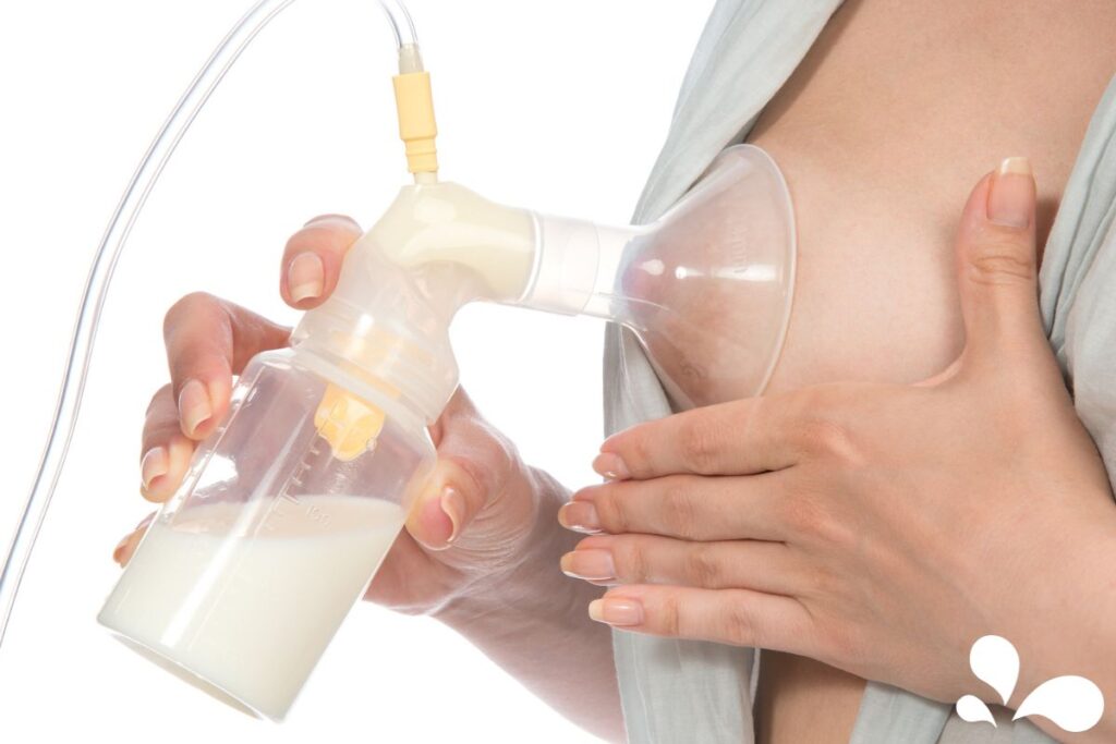 Close-up of a manual breast pump in use, showing the collection of breast milk into an attached bottle.