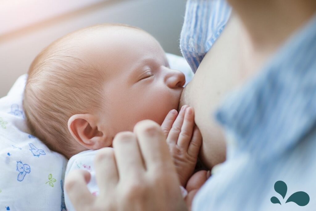 A newborn baby peacefully breastfeeding, cradled in a mother's arms, symbolizing the intimacy and nurturing nature of the bond between mother and child.