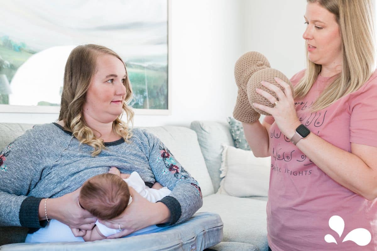 Anna Burch (IBCLC) demonstrating latch to a new mama.