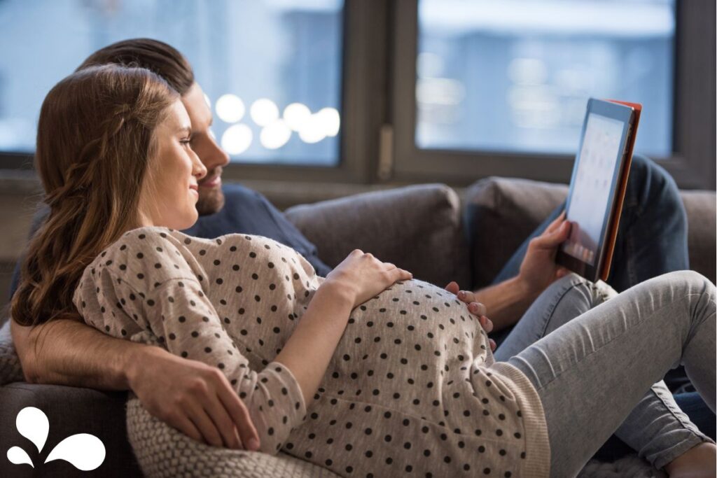 pregnant mama and partner looking at a digital screen