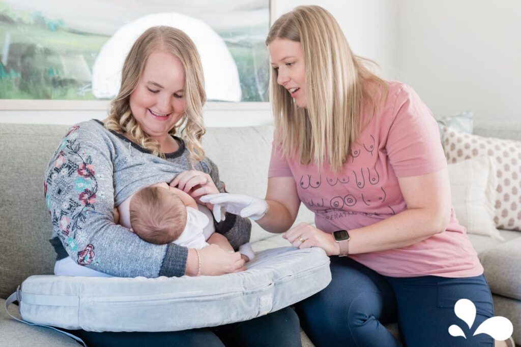 Anna Burch (IBCLC) providing breastfeeding support to a new mama